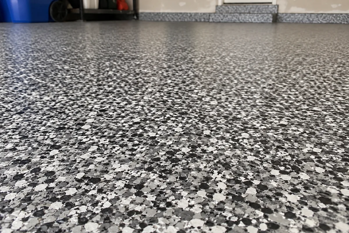 Close-up of a dense grey flake floor with a high-gloss topcoat