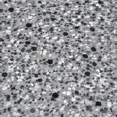 Close-up of grey, white and black flake chips of mixed sizes